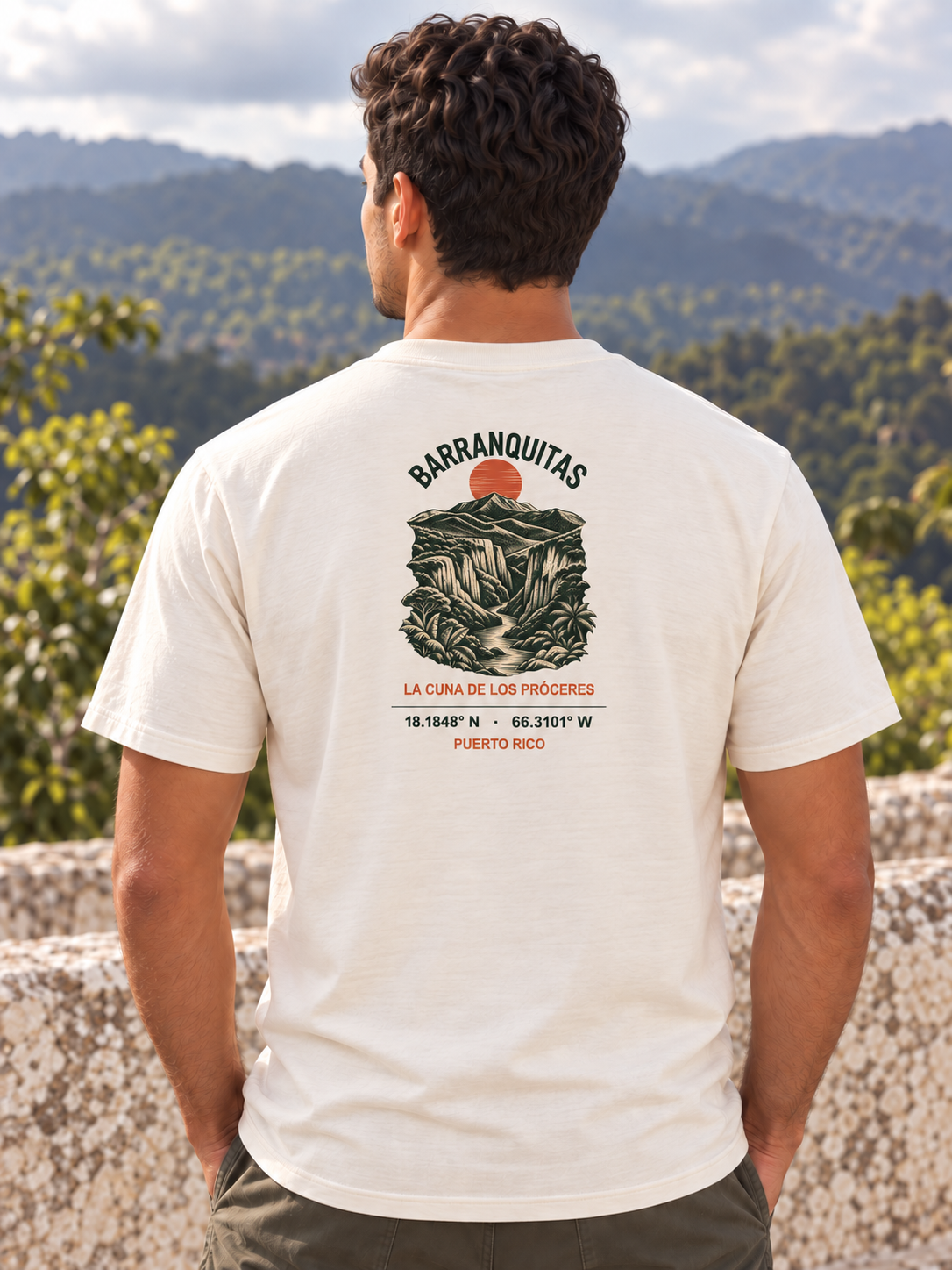 AI-generated styling visualization: man wearing the ivory Barranquitas tee from behind, with the back print scaled to match the supplier mockup.